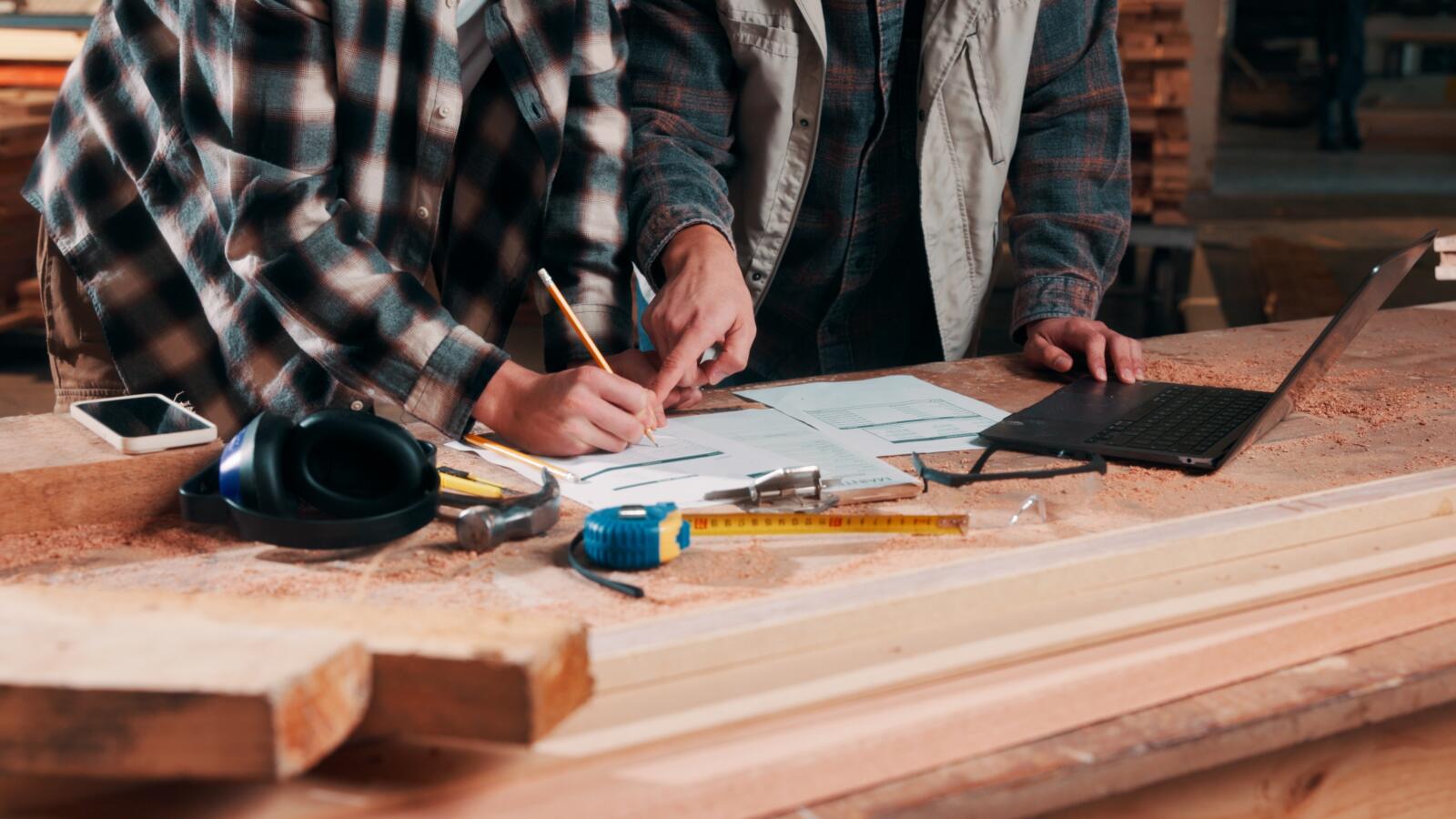 Hands,,Writing,And,Documents,In,Lumber,Workshop,,Carpenter,And,Team